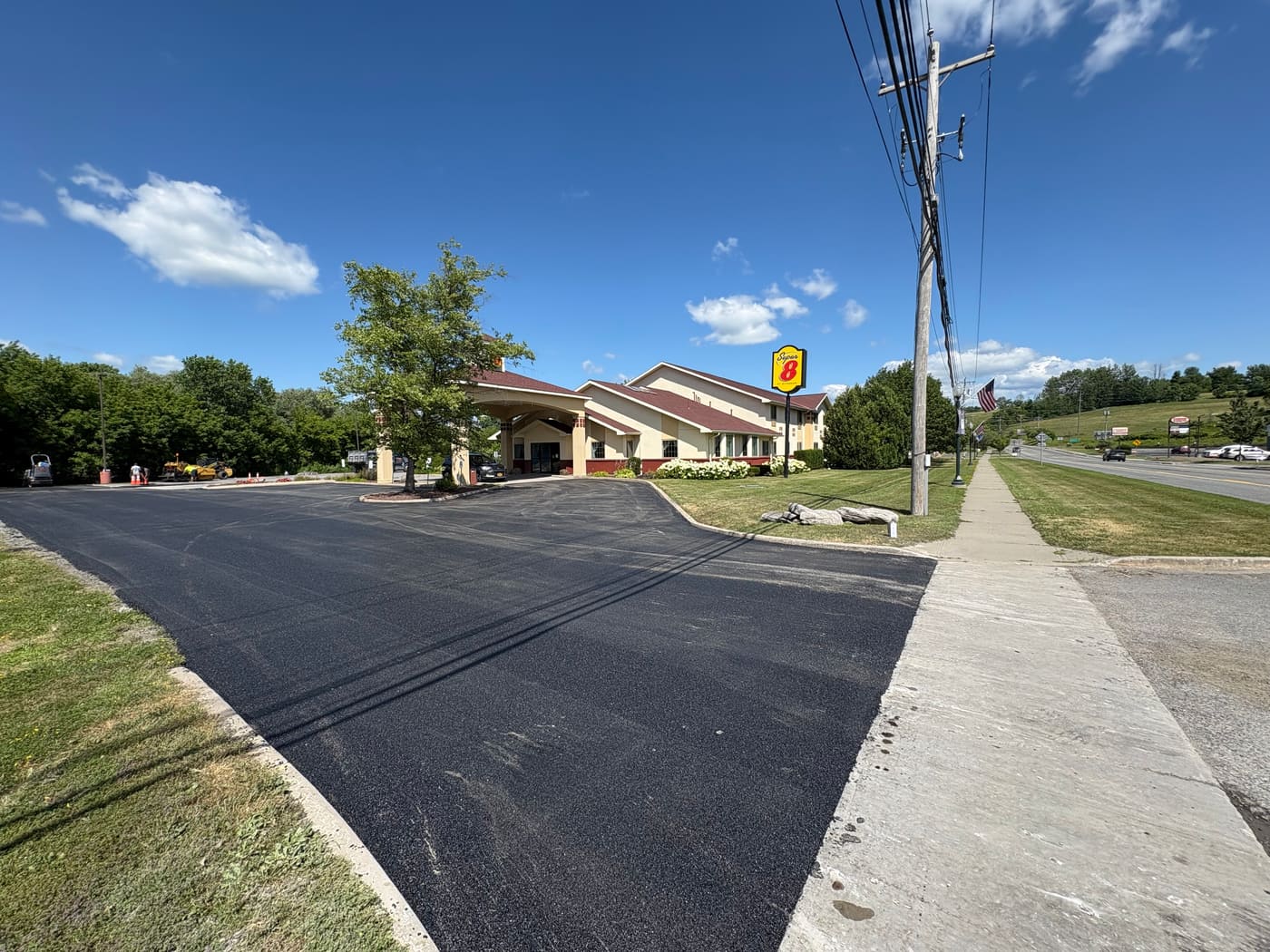 Freshly paved commercial road extension at a hotel property